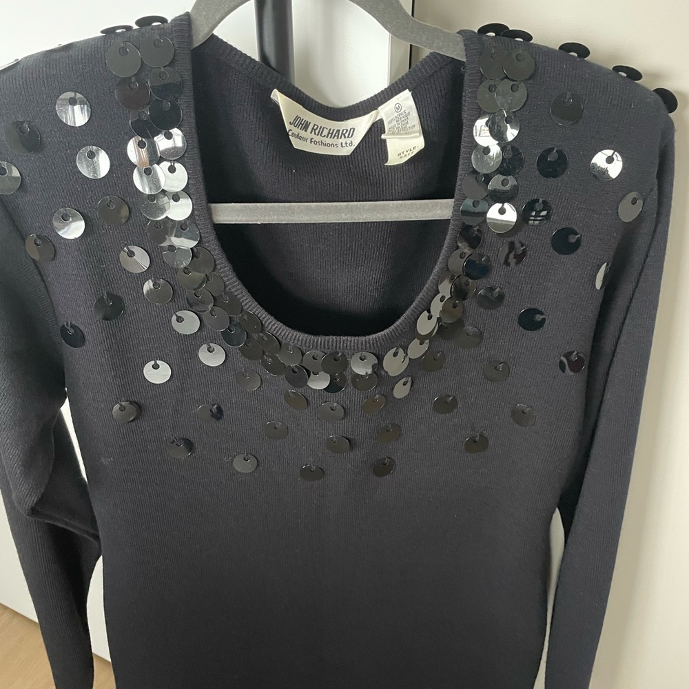 Black knit dress with decorative sequins.